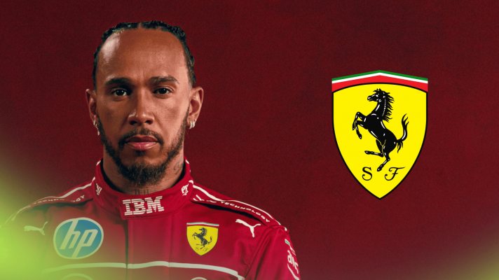 Lewis Hamilton poses in Ferrari overalls with a prominent Ferrari logo alongside him against a red background