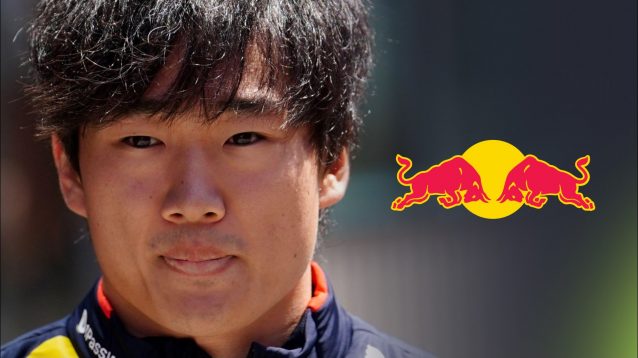 Yuki Tsunoda pictured at the 2025 Emilia Romagna Grand Prix, with a Red Bull logo to his right