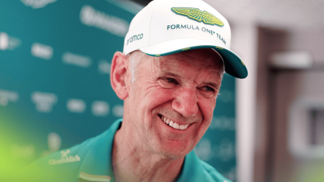 Adrian Newey smiles broadly while wearing Aston Martin team kit