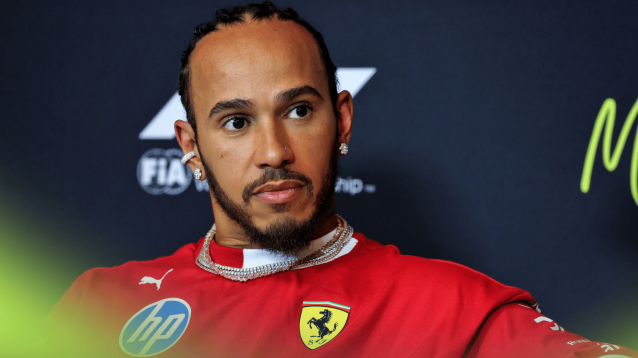 Lewis Hamilton looks on in a press conference