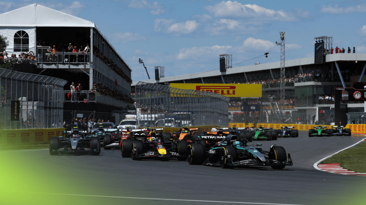 A ground-level shot of George Russell leading the field into the first corner in Canada