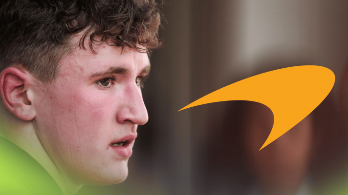 A close-up shot of Alex Dunne with a prominent McLaren logo alongside him
