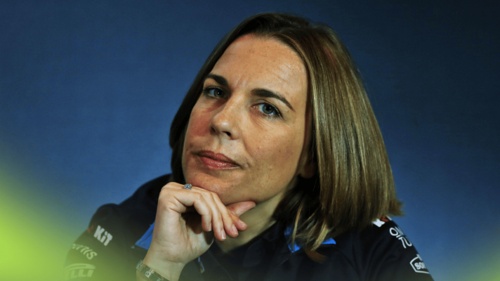 Claire Williams eyes the camera while resting her chin on her hand in a press conference