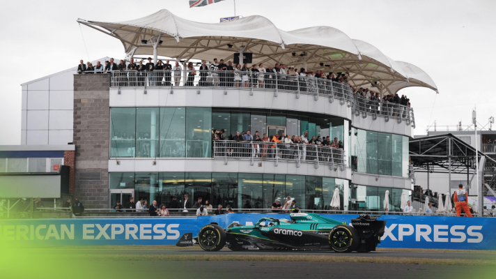 Fernando Alonso's Aston Martin passes the BRDC clubhouse in practice at Silverstone