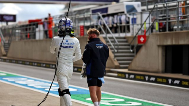 Alex Albon walks down the pit lane after Q2 exit