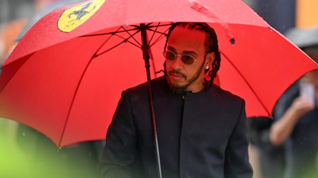 Lewis Hamilton under a Ferrari umbrella at the 2025 British Grand Prix