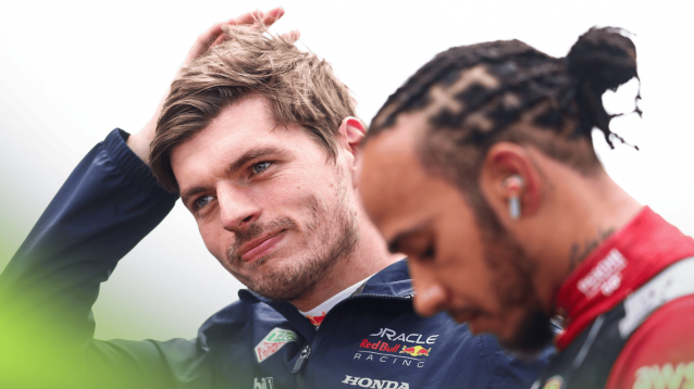 Max Verstappen looks on during the national anthem at Silverstone as Lewis Hamilton stares at the floor