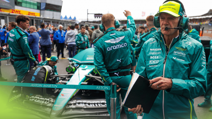 Adrian Newey stands in front of the Aston Martin AMR25 on the grid at Silverstone