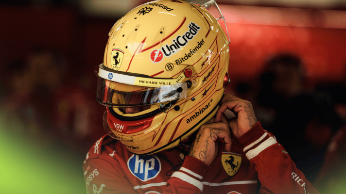 Lewis Hamilton fastens his helmet in the Ferrari garage at Silverstone