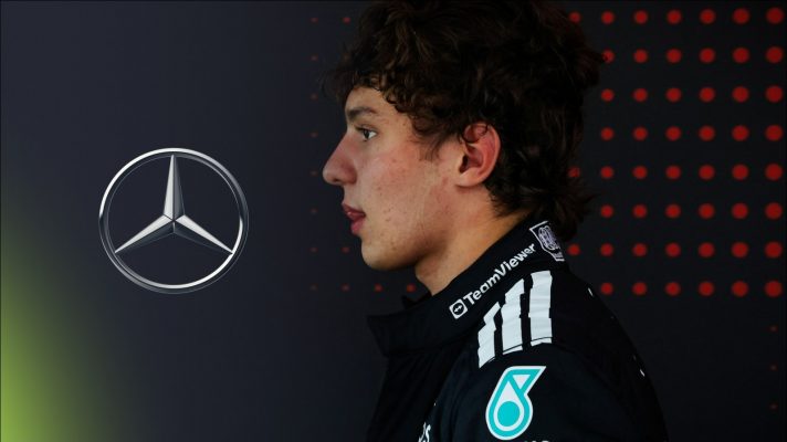 Mercedes driver Kimi Antonelli pictured at the 2025 Belgian Grand Prix, looking towards a Mercedes logo on his left