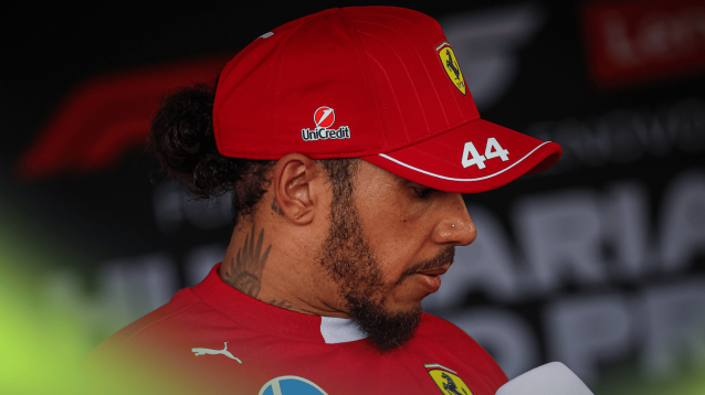 Lewis Hamilton looks at the floor as he faces the media in Hungary
