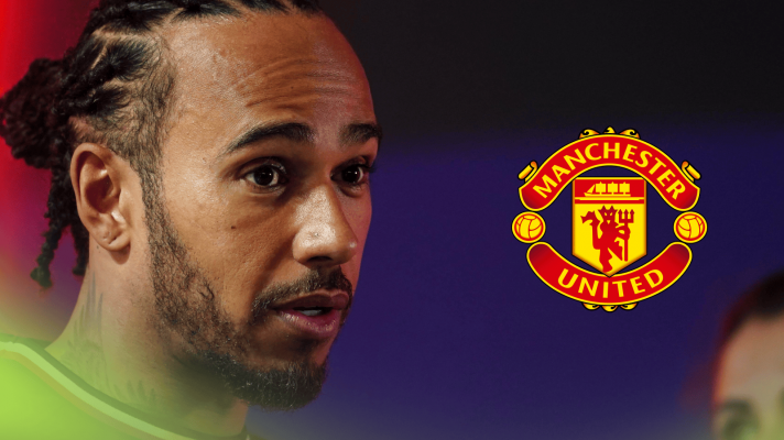 Lewis Hamilton looks surprised with a prominent Manchester United logo alongside him