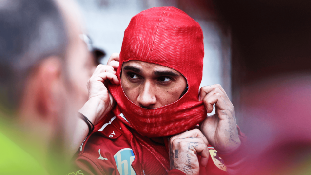 Lewis Hamilton eyes and nose are visible as he puts on his balaclava on the grid in China