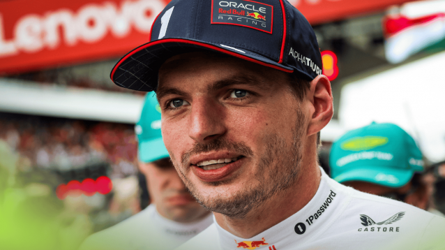 Max Verstappen smiles as he prepares for the start of the 2025 Hungarian Grand Prix
