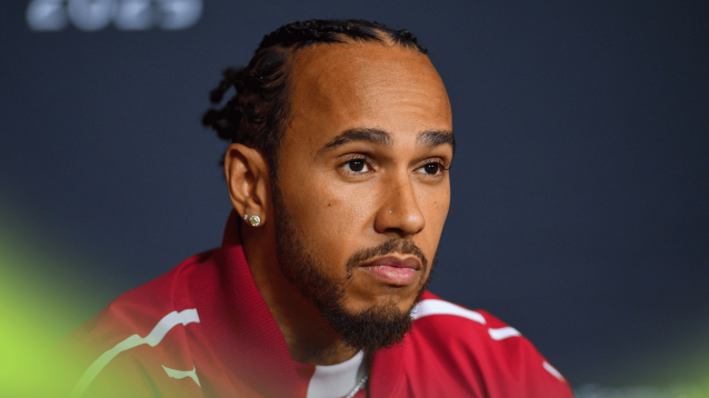 Lewis Hamilton looks on glumly in a press conference
