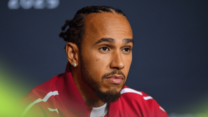Lewis Hamilton looks on glumly in a press conference