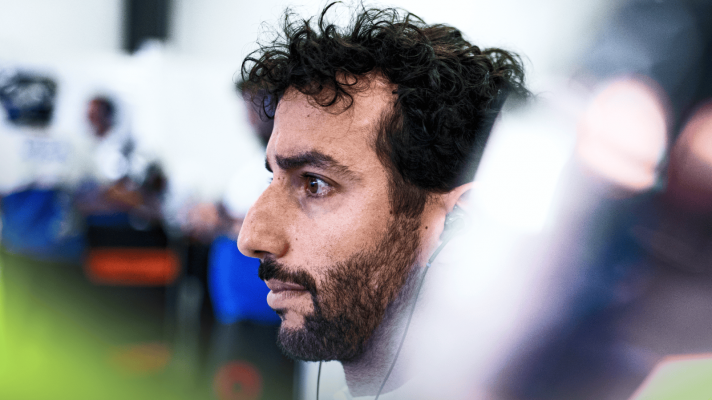 Daniel Ricciardo stares into the distance in the Racing Bulls garage