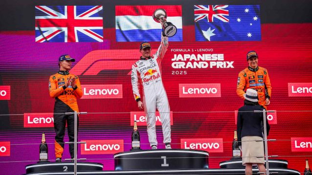 Max Verstappen with the McLaren drivers on the Japanese GP podium.