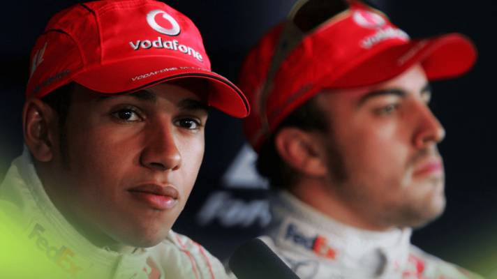 Lewis Hamilton looks on in a press conference in 2007 with Fernando Alonso in the background