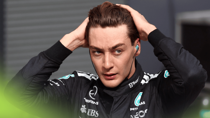 George Russell runs his hands through his hair in parc ferme