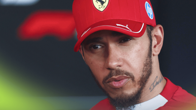 Lewis Hamilton listens to a question while facing the media in Hungary