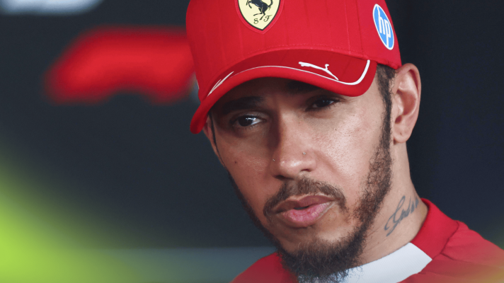 Lewis Hamilton listens to a question while facing the media in Hungary