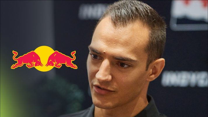Multi-time IndyCar champion Alex Palou speaks to media, as a Red Bull logo appears on his left