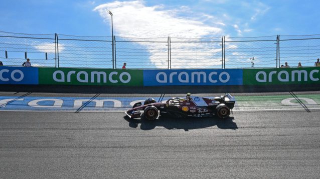 Lewis Hamilton takes the high line through the banked corner