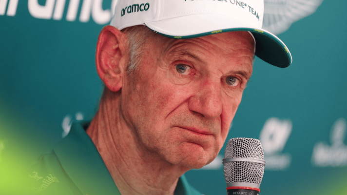 Adrian Newey wearing Aston Martin team kit in a press conference