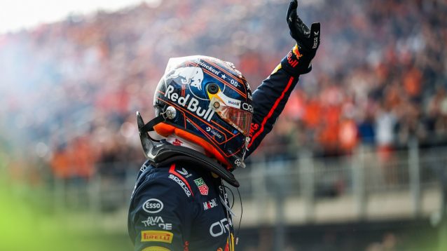 Red Bull's Max Verstappen in focus as he waves to the crowd at the 2025 Dutch Grand Prix