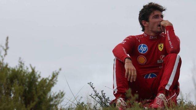 Charles Leclerc sat on a hill at Zandvoort.