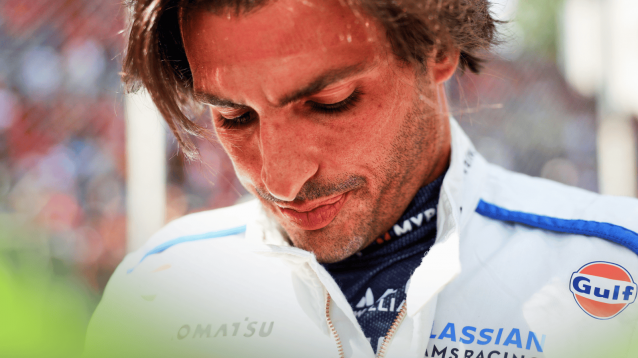 A close-up shot of Carlos Sainz on the grid at Monza