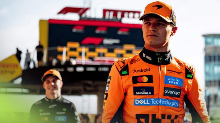 Lando Norris scowls in the Monza pit lane with Oscar Piastri smiling in the background