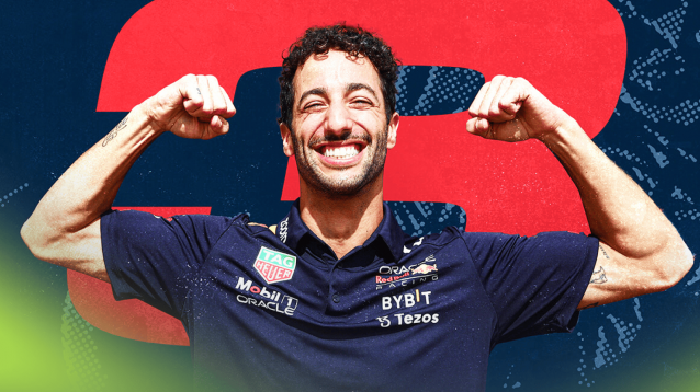 Daniel Ricciardo smiles as he flexes his muscles while wearing Red Bull team kit