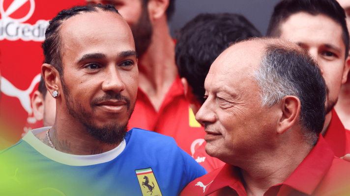Fred Vasseur smiles at Lewis Hamilton during a Ferrari team photoshoot in the paddock