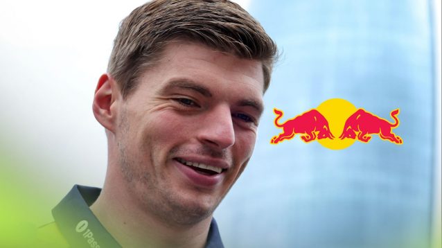Max Verstappen smiling at the 2025 Azerbaijan Grand Prix, as the Red Bull logo appears on his right