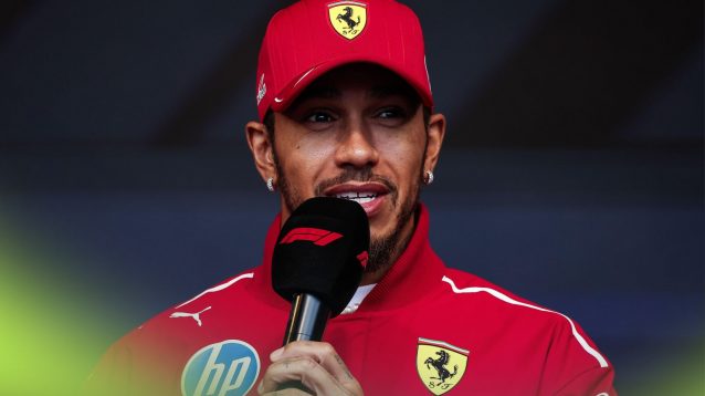 Ferrari driver Lewis Hamilton holding an 'F1' branded microphone at the 2025 Azerbaijan Grand Prix