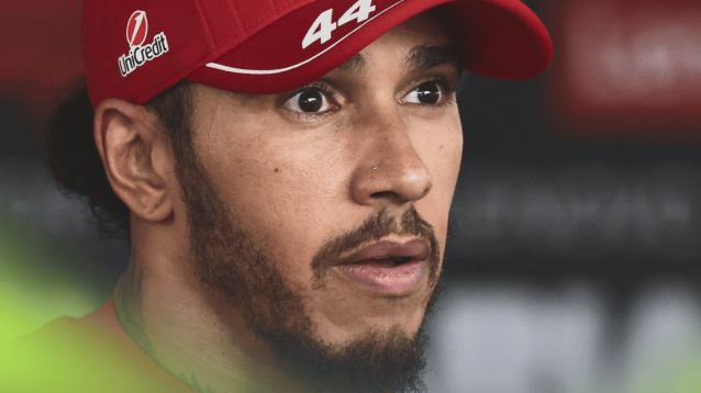 A close-up shot of Lewis Hamilton with a shocked facial expression