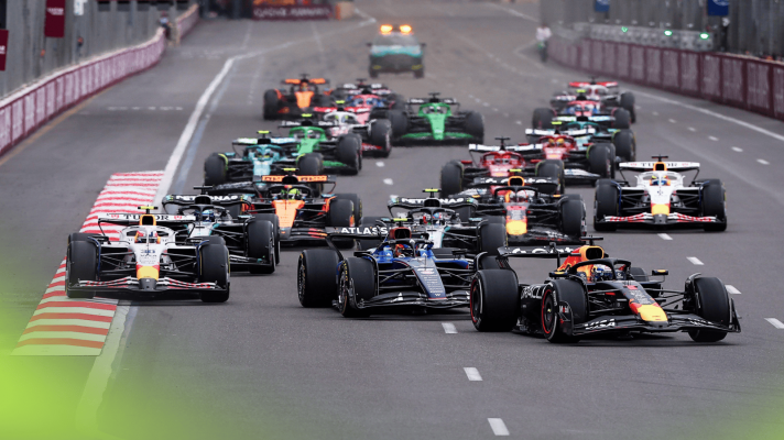 The F1 field, led by Max Verstappen, approaches the first corner at the 2025 Azerbaijan Grand Prix