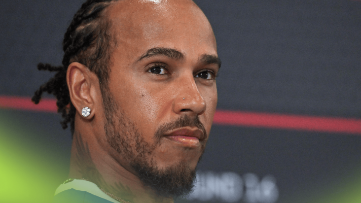 A close-up shot of Lewis Hamilton in a press conference