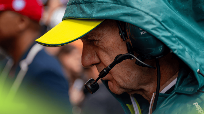 A close-up shot of Adrian Newey on the grid with his hood up