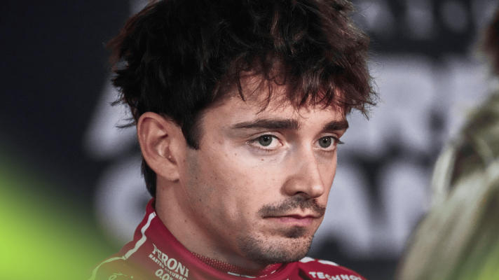 Charles Leclerc frowns as he faces the media