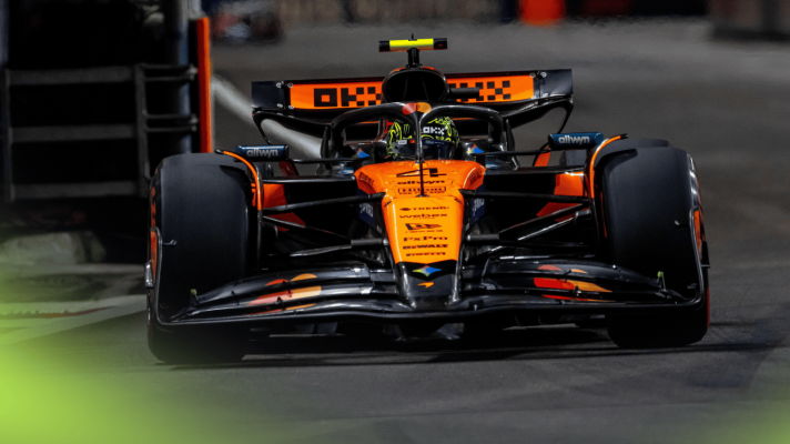 An action shot of Lando Norris on track under the lights in Singapore