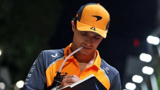 Lando Norris drinks at the Singapore Grand Prix.