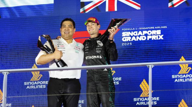 Mercedes' George Russell with Tengku Muhammad Taufik on the podium at the 2025 Singapore Grand Prix.