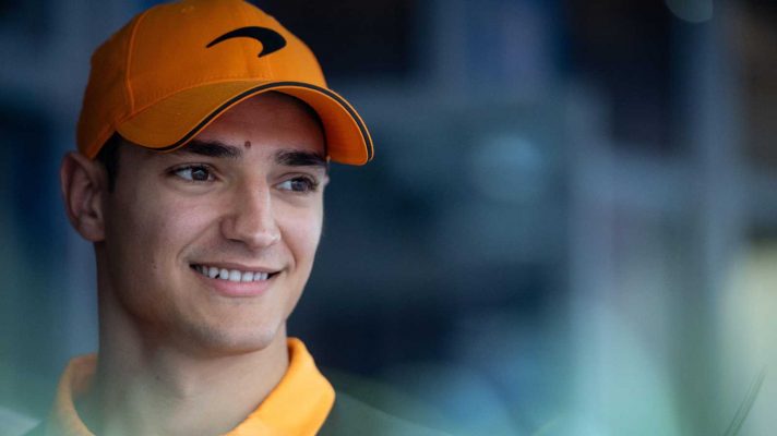 Alex Palou smiles while wearing McLaren team kit in 2022