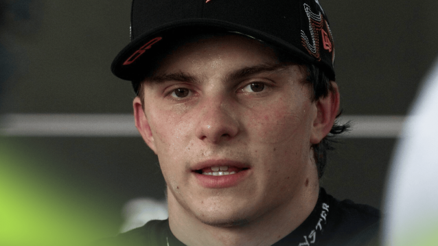 Oscar Piastri eyes the camera as he faces the media