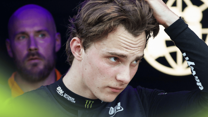Oscar Piastri runs his hands through his hair as he exits the FIA garage
