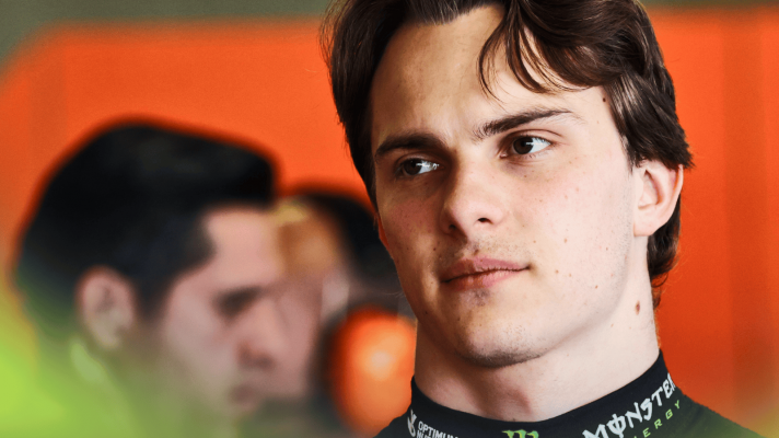 Oscar Piastri looks on in the McLaren garage