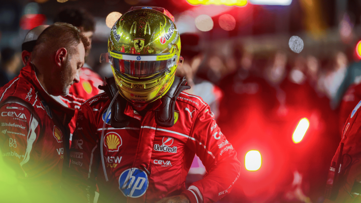 Lewis Hamilton on the Singapore GP grid with the red light at the rear of his car illuminated in the background